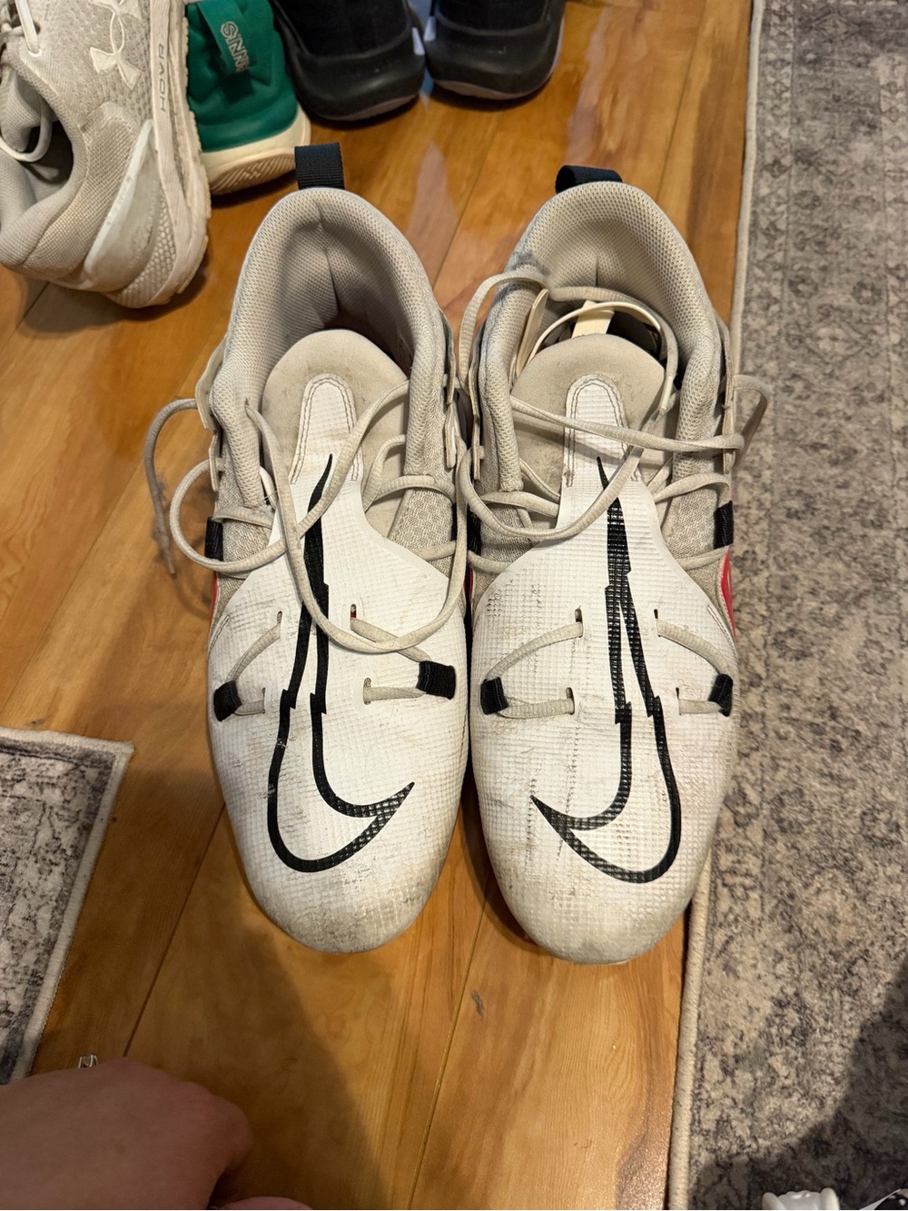 Nike men’s football cleats  White Sneakers with Black Swoosh and Red Accent